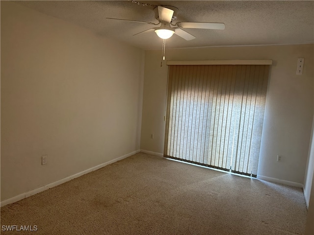 spare room with a textured ceiling and ceiling fan