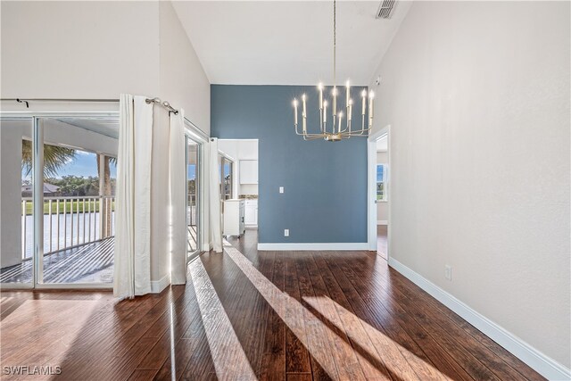 unfurnished dining area featuring dark hardwood / wood-style floors and a notable chandelier