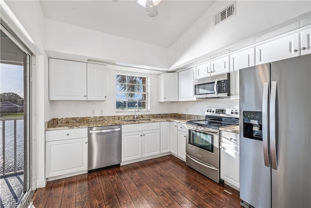 kitchen with stainless steel appliances, dark hardwood / wood-style floors, sink, vaulted ceiling, and white cabinets