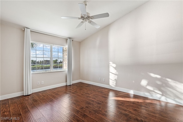 spare room featuring dark wood-type flooring, ceiling fan, and lofted ceiling