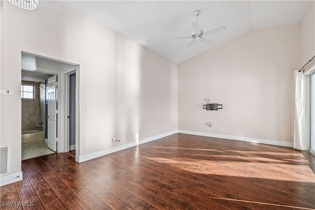 empty room with ceiling fan, dark hardwood / wood-style floors, and high vaulted ceiling