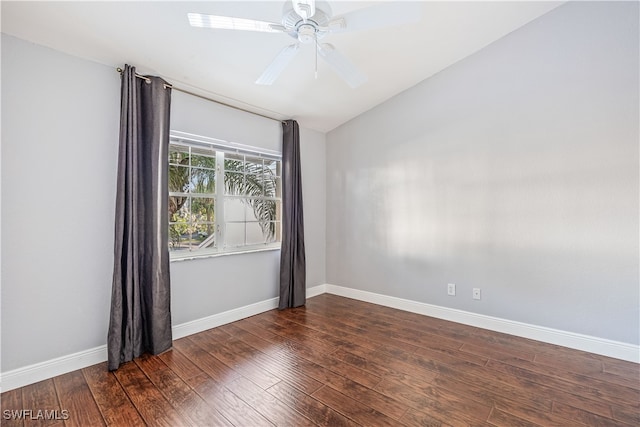 empty room featuring dark wood-type flooring, ceiling fan, and vaulted ceiling