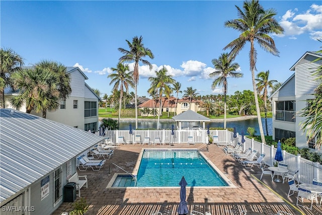 view of swimming pool with a gazebo, a water view, and a patio area