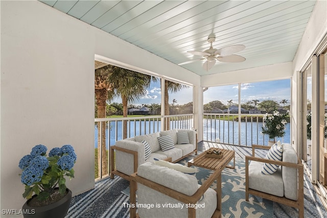 sunroom / solarium featuring ceiling fan, wood ceiling, and a water view