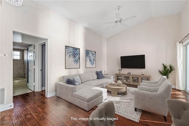 living room featuring dark wood-type flooring, high vaulted ceiling, and ceiling fan