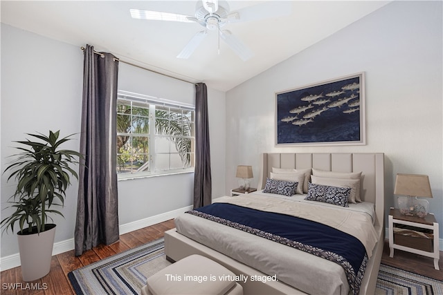 bedroom featuring ceiling fan, dark hardwood / wood-style floors, and vaulted ceiling