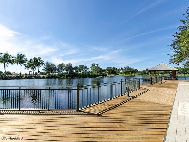 view of dock with a gazebo and a water view