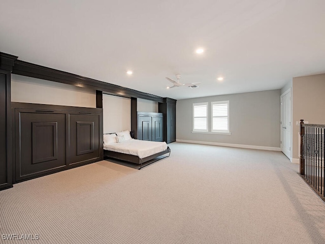 unfurnished bedroom featuring light colored carpet and ceiling fan