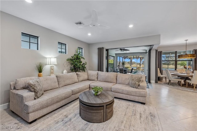 tiled living room with ceiling fan