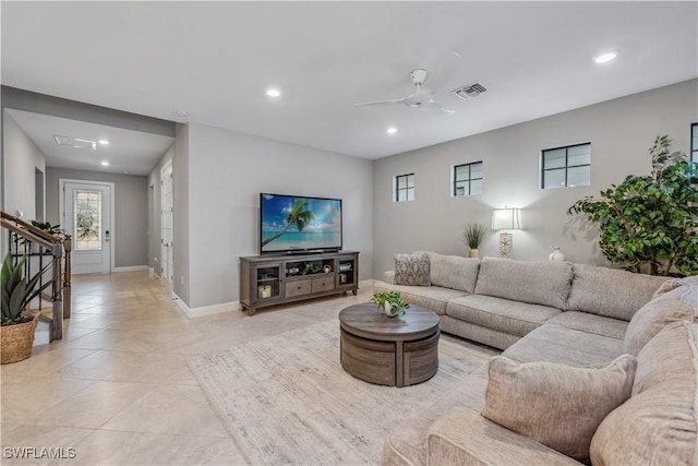 tiled living room with ceiling fan