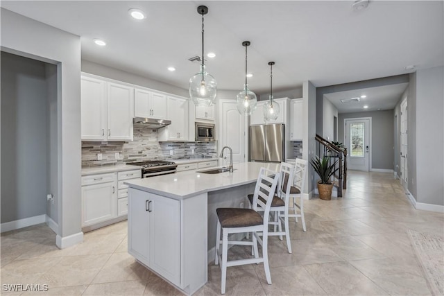 kitchen featuring appliances with stainless steel finishes, white cabinetry, and sink