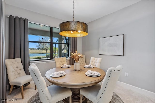 dining area featuring a water view