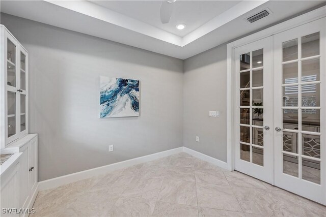 unfurnished room featuring french doors