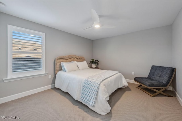 carpeted bedroom with baseboards and a ceiling fan
