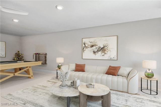 living area featuring baseboards and recessed lighting