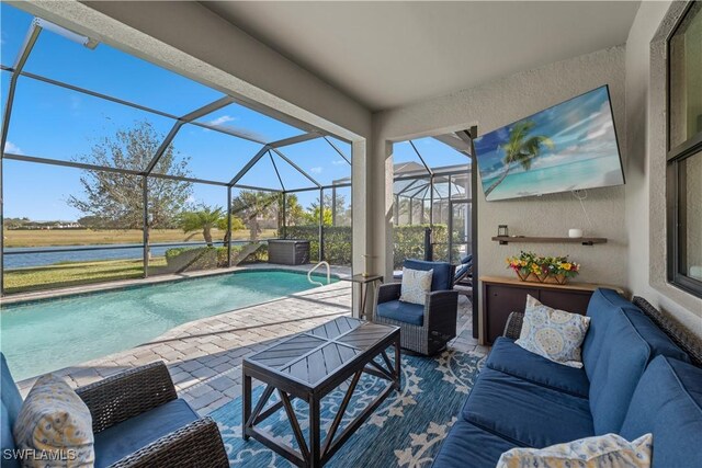 view of pool with a water view, a patio, glass enclosure, and an outdoor living space