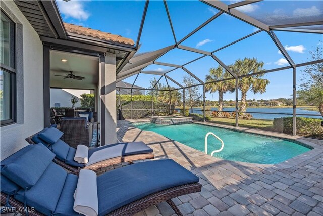 view of swimming pool with a lanai, a patio area, an in ground hot tub, and a water view