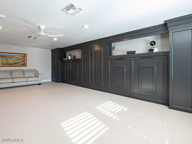 unfurnished living room with light carpet and ceiling fan