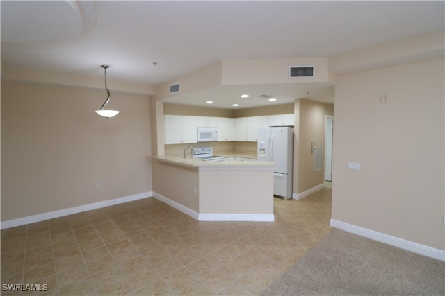 kitchen featuring pendant lighting, kitchen peninsula, white cabinets, and white appliances