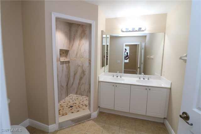 bathroom featuring vanity, tile patterned flooring, and tiled shower