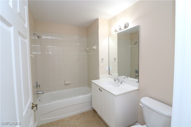 full bathroom with toilet, tiled shower / bath combo, vanity, and tile patterned flooring