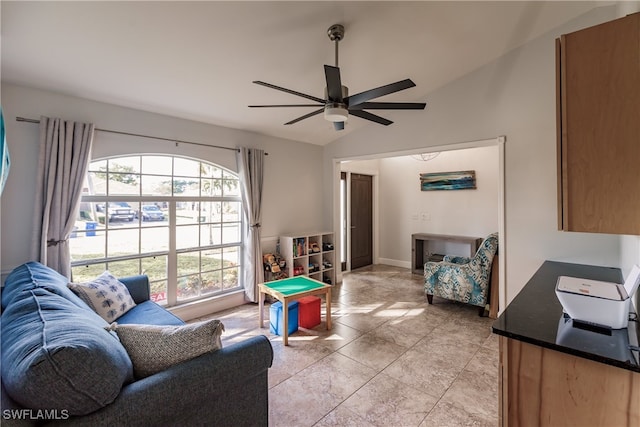 tiled living room featuring ceiling fan and lofted ceiling