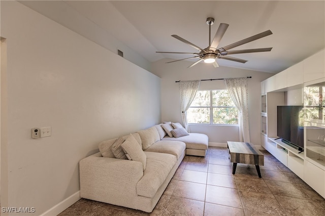 tiled living room featuring ceiling fan and vaulted ceiling