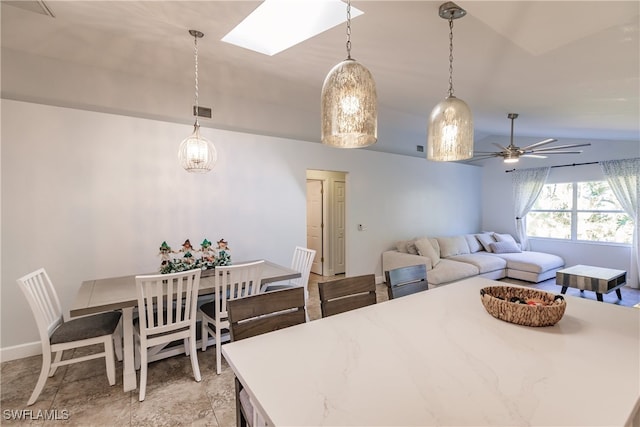 dining space with lofted ceiling with skylight and ceiling fan