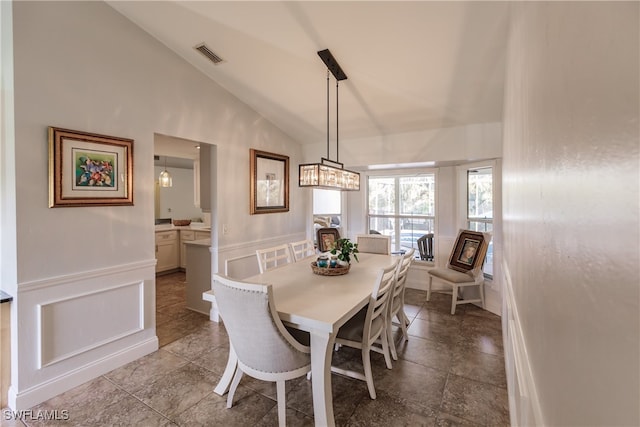 dining area featuring high vaulted ceiling