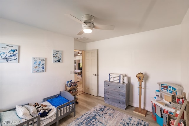 bedroom with ceiling fan and light wood-type flooring