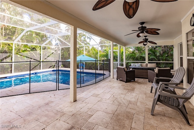 view of pool featuring a lanai, outdoor lounge area, ceiling fan, and a patio