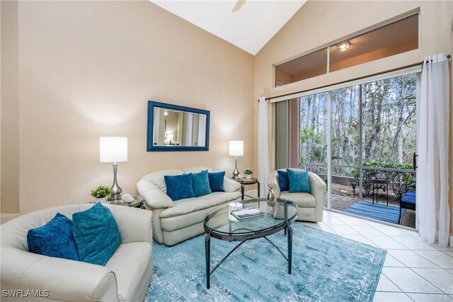 living room featuring vaulted ceiling, light tile patterned floors, and ceiling fan