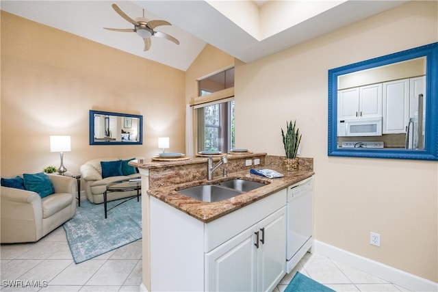 kitchen featuring white appliances, stone countertops, a sink, and white cabinets