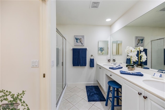 full bath with a stall shower, tile patterned flooring, visible vents, and a sink