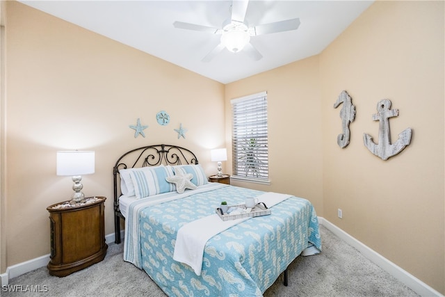 bedroom featuring light colored carpet, ceiling fan, and baseboards