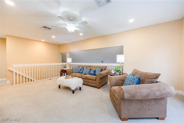 living room with recessed lighting, visible vents, a ceiling fan, and light colored carpet