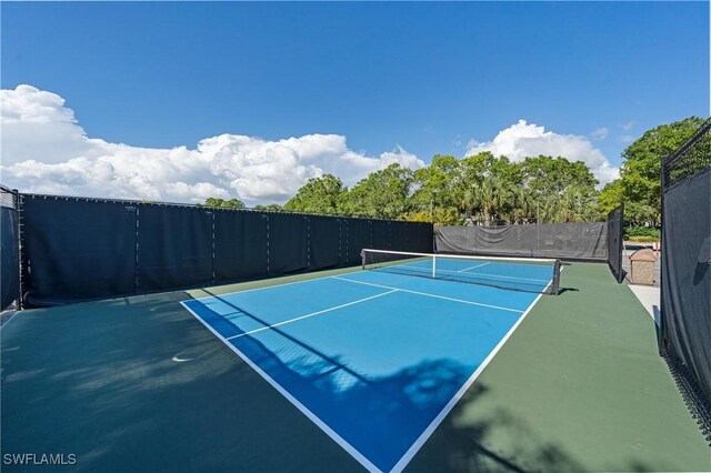 view of tennis court featuring fence