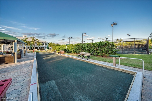 view of road featuring street lights and curbs