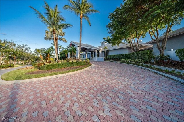 view of front of home with decorative driveway and stucco siding