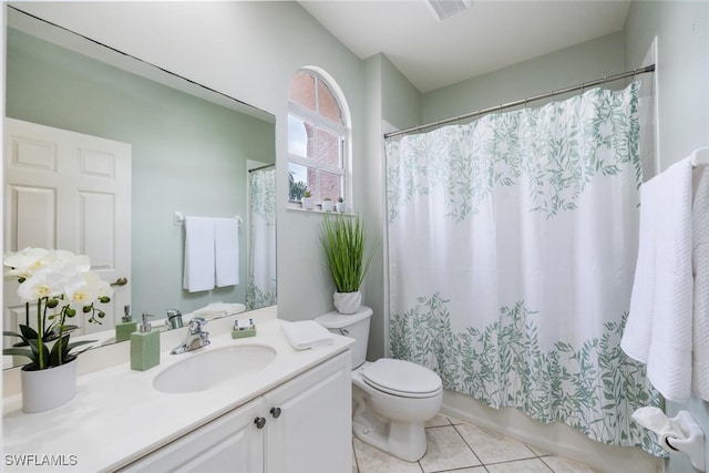 bathroom featuring vanity, toilet, and tile patterned floors