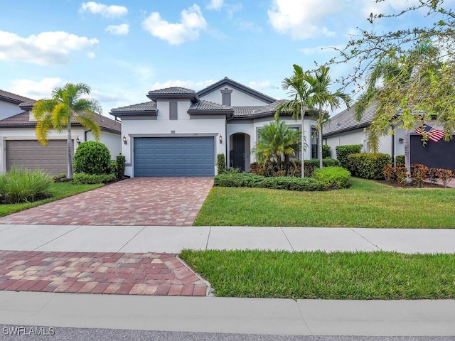 mediterranean / spanish-style house featuring a front lawn and a garage