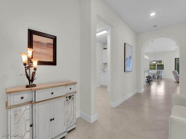 hall featuring light tile patterned floors