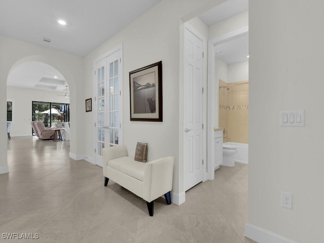 hall featuring light tile patterned floors