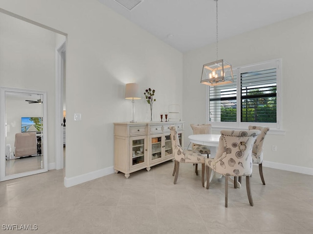 dining area featuring light tile patterned flooring and an inviting chandelier