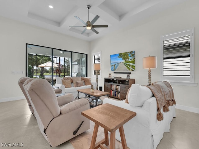 tiled living room with ceiling fan and coffered ceiling