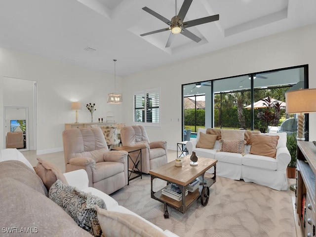 living room with coffered ceiling and ceiling fan