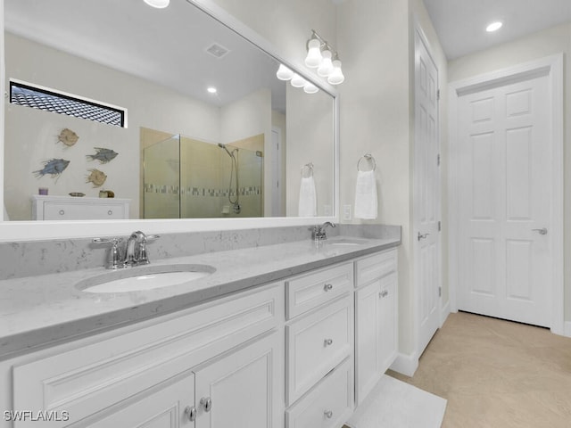 bathroom featuring vanity, an enclosed shower, and tile patterned floors