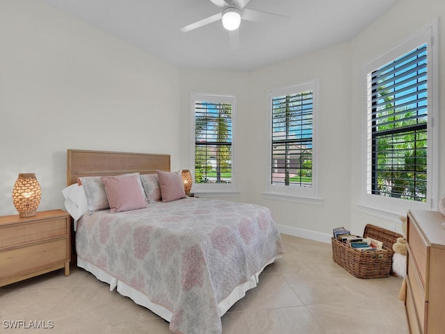 tiled bedroom with multiple windows and ceiling fan