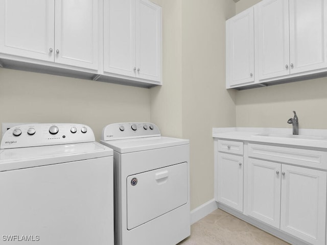 laundry area with independent washer and dryer, sink, and cabinets