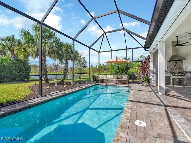 view of pool featuring outdoor lounge area, a patio area, exterior kitchen, a lanai, and ceiling fan